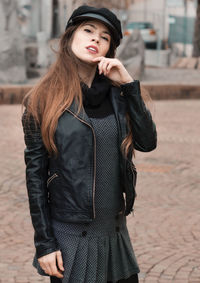 Portrait of beautiful young woman standing outdoors