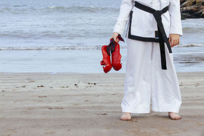 Rear view of woman standing on beach