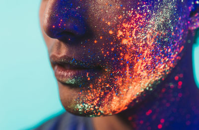 Close-up of man with multi colored face paint