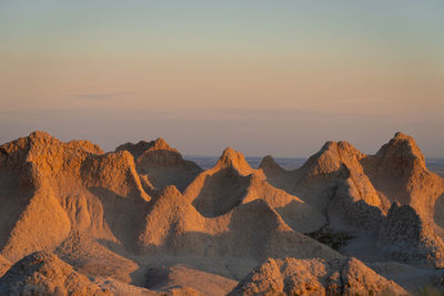 Scenic view of rock formations against sky during sunset