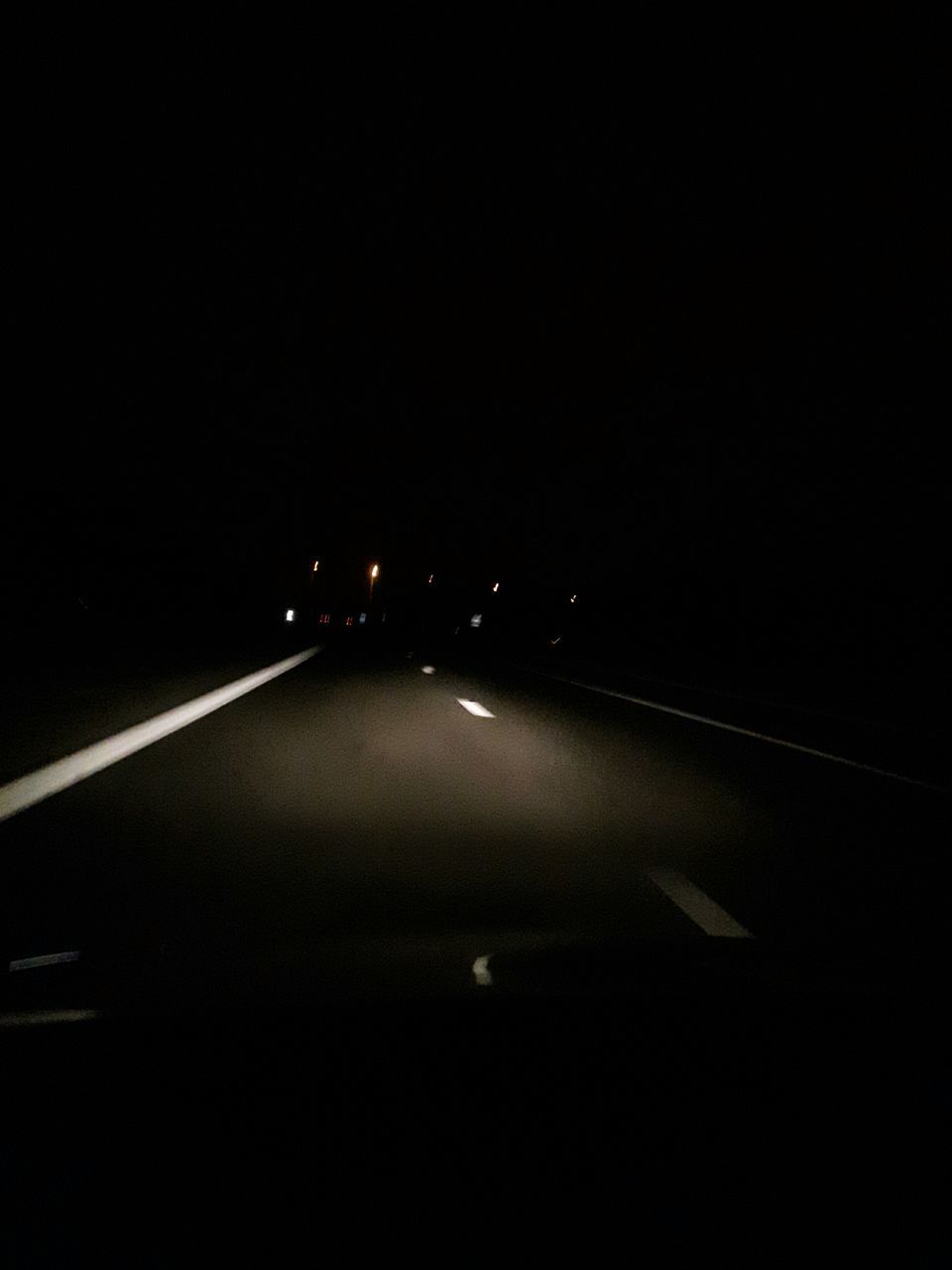 night, illuminated, transportation, the way forward, road, copy space, road marking, diminishing perspective, dark, vanishing point, lighting equipment, street, street light, empty, no people, clear sky, indoors, light - natural phenomenon, asphalt, car