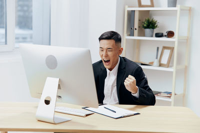 Businesswoman using laptop at office