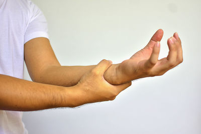 Close-up of hands over white background