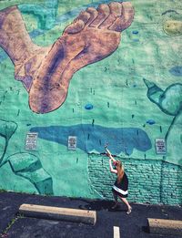 Man with graffiti on wall