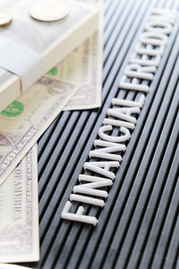 High angle view of paper currency and texts on table