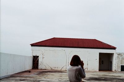 Rear view of woman against clear sky