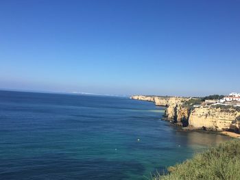 Scenic view of sea against clear blue sky