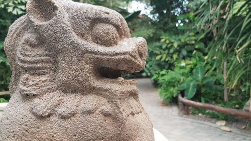 Close-up of buddha statue in park