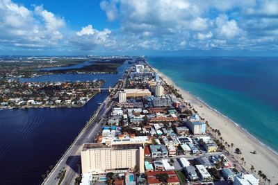 High angle view of sea and buildings against sky