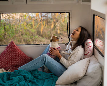 Portrait of young woman sitting on sofa at home