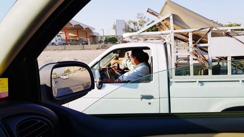 Man sitting on car window