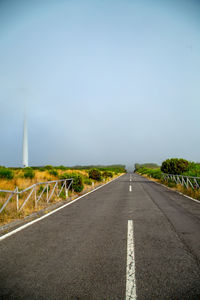 Country road against sky