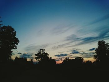 Silhouette of trees against sky at sunset