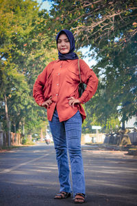 Portrait of man standing on road in city