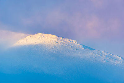 Scenic view of snowcapped mountain against sky