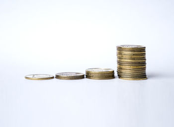 Close-up of coin stack against white background