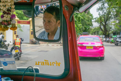 Portrait of man sitting in car