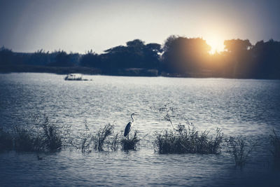 Scenic view of lake against sky during sunset