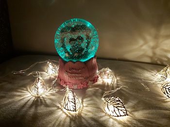 Close-up of illuminated lighting equipment on table at home