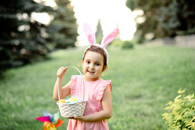 Portrait of cute girl blowing bubbles in park