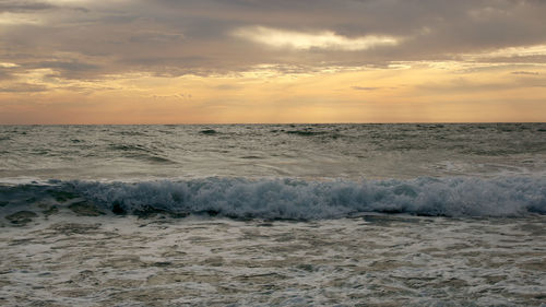 Beautiful sunset on the beach. the surf pounds the shore. phuket, thailand