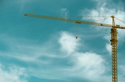 Low angle view of crane against sky