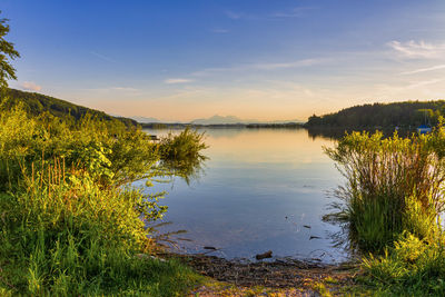 Scenic view of lake against sky during sunset