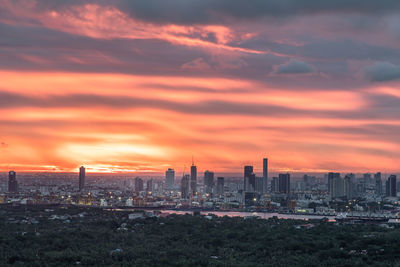 Scenic view of buildings against sky during sunset