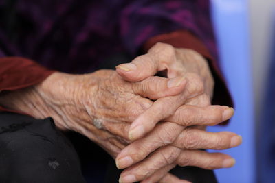 Midsection of senior woman with clasped hands