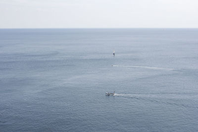 High angle view of boat sailing in sea against sky