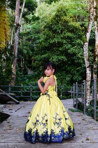 Full length of woman standing against yellow trees