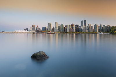 Panoramic view of sea and buildings against sky