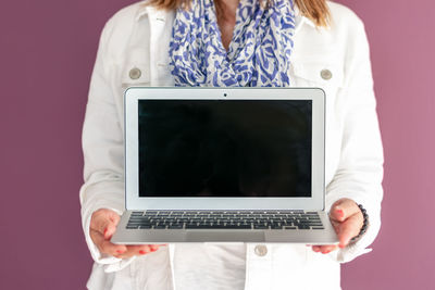 Midsection of woman using mobile phone