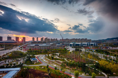 High angle view of river amidst buildings against sky