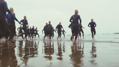 Divers running at beach