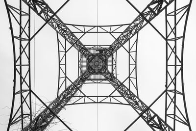 Low angle view of electricity pylon against sky