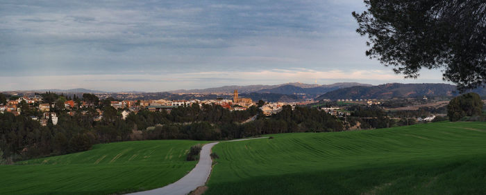 Scenic view of green landscape against sky