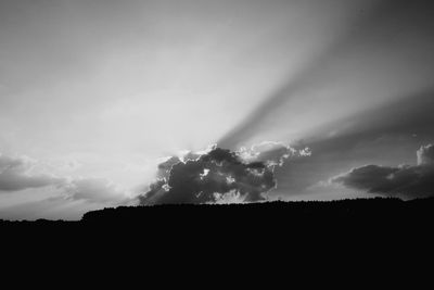 Low angle view of silhouette trees against sky