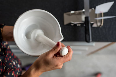 Cropped image of pharmacist preparing medicine using mortar and pestle