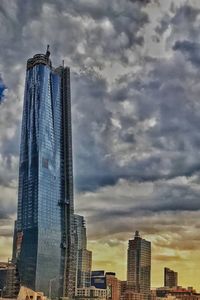 Low angle view of buildings against cloudy sky