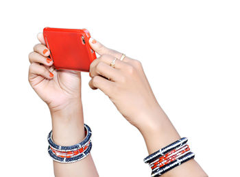 Close-up of woman holding book against white background