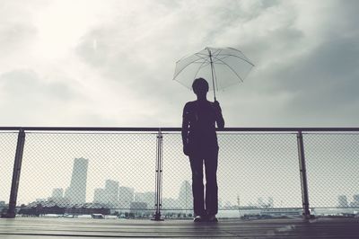 Low angle view of person holding umbrella