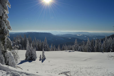 Scenic view of snow covered mountains against sky