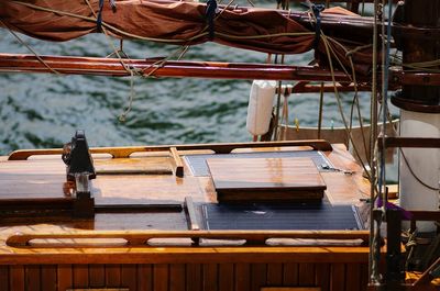 Rope tied to moored boat in water