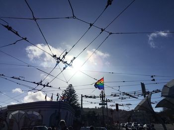 Low angle view of power cables against sky