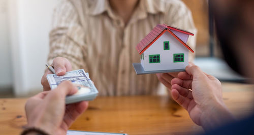 Close-up of woman holding hands with text on table