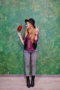 Full length of woman wearing hat standing outdoors