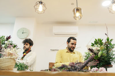 Florists arranging flowers at shop