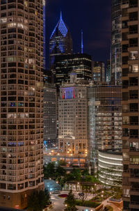 Illuminated modern buildings in city at night