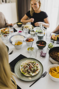 Group of friends eating mexican food at home